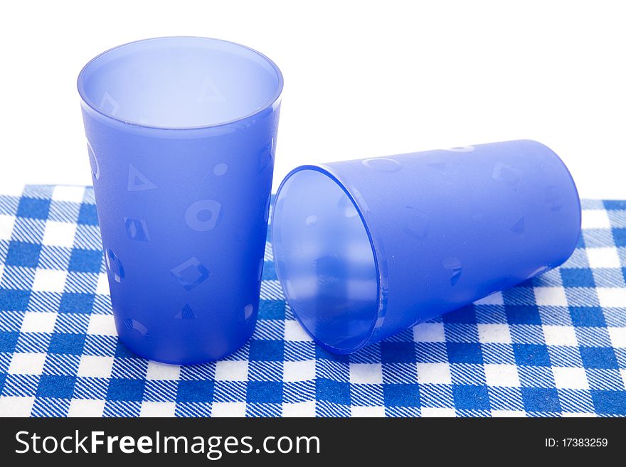 Blue cups on blue white table cloth