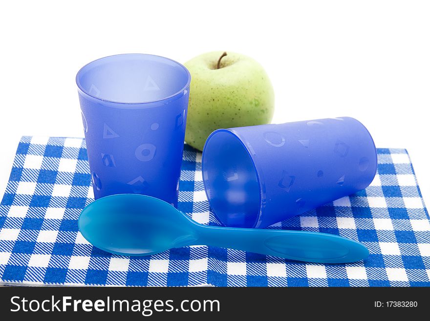 Blue cups and cutlery with apple. Blue cups and cutlery with apple