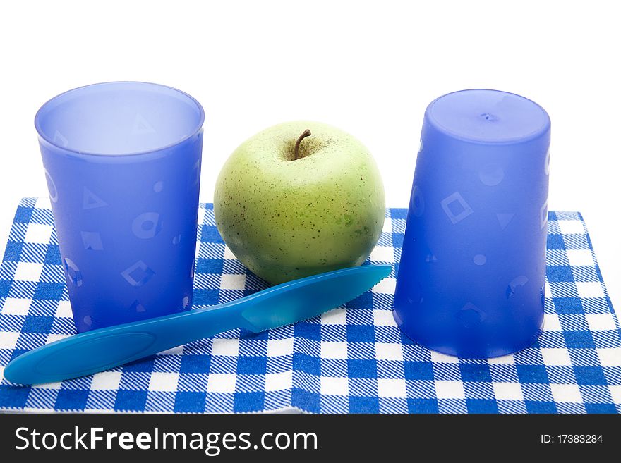 Blue cups and cutlery with apple. Blue cups and cutlery with apple
