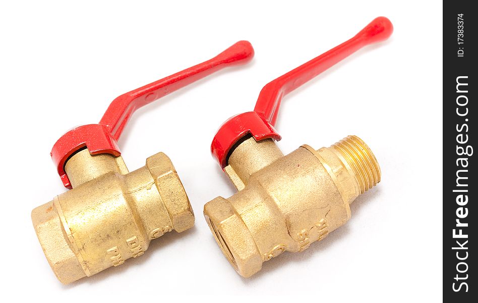 Brass cranes with the red handle close up