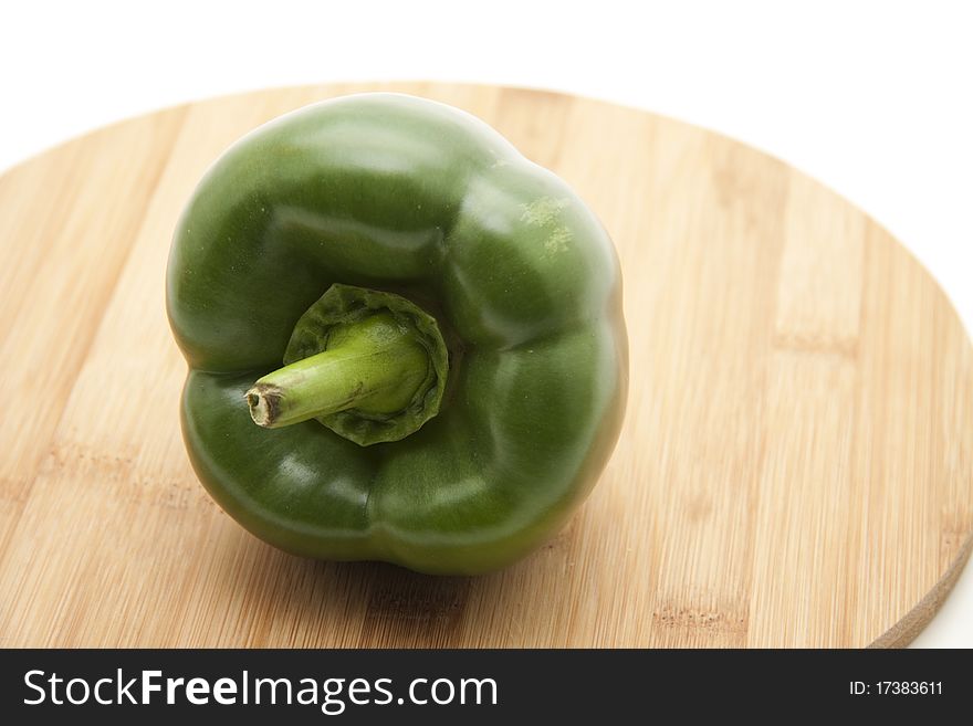 Greens paprikas onto wood plates