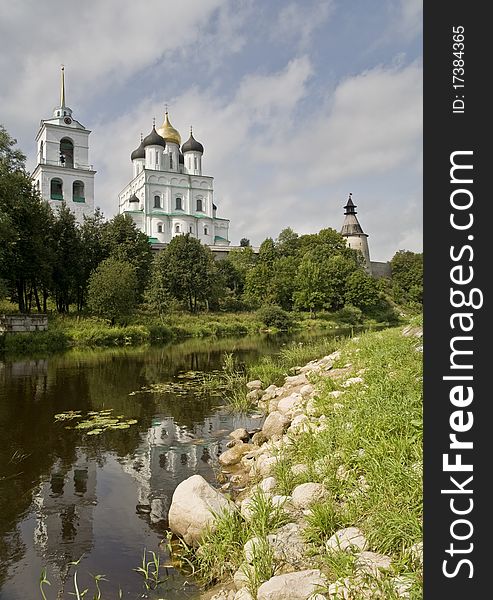 The Pskov temple in an environment of the trees, standing on the river. The Pskov temple in an environment of the trees, standing on the river