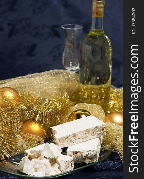 White nougat with Christmas decorations on a blue background