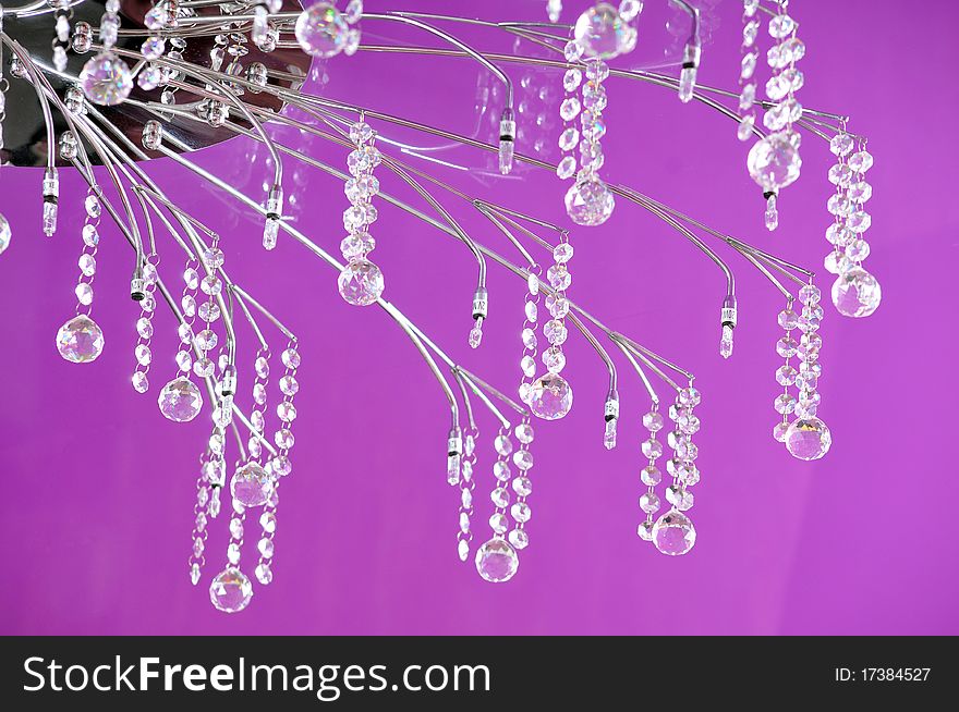 Graceful chandelier on a lilac ceiling at restaurant. Graceful chandelier on a lilac ceiling at restaurant.