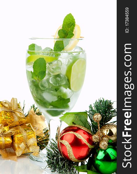 Mojito Party Club Cocktail with mint leaves, vodka, lime, simple syrup, light bacardi rum, club soda and candy cane and christmas New Year ornament decoration isolated on a white background. Mojito Party Club Cocktail with mint leaves, vodka, lime, simple syrup, light bacardi rum, club soda and candy cane and christmas New Year ornament decoration isolated on a white background