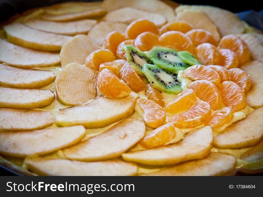 Fresh ingredients ready for a fruit cake: kiwi, apple and mandarin