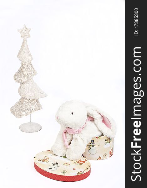 White Christmas tree and a toy white rabbit in a gift box symbol 2011