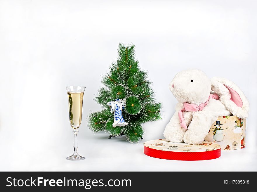 Christmas tree decorated. The right of the tree symbol in 2011 the white rabbit, left a glass of champagne. Christmas tree decorated. The right of the tree symbol in 2011 the white rabbit, left a glass of champagne.