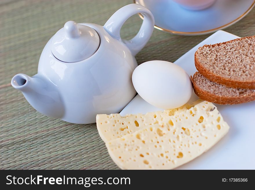 A set tabled for tea with sheep cheese