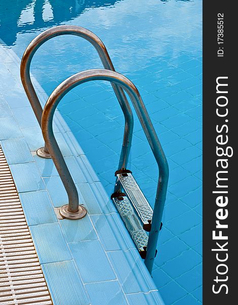 Steel handrails and stairs in the swimming pool. Steel handrails and stairs in the swimming pool
