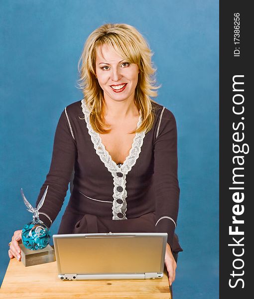 Attractive smiling businesswoman with  cup and laptop