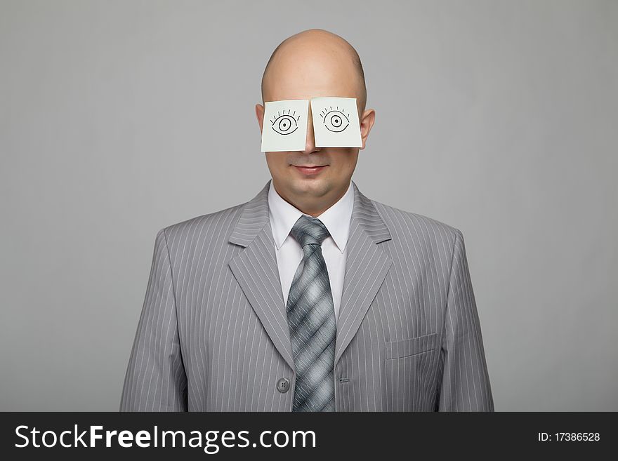 Bald businessman in a gray suit