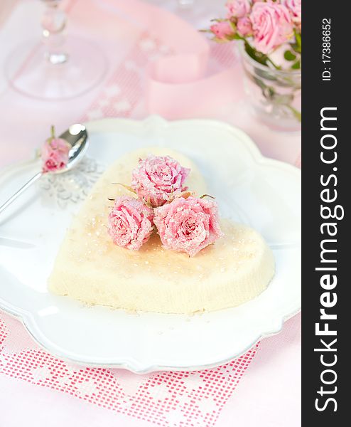 Heart-shaped ricotta dessert with candied roses. Heart-shaped ricotta dessert with candied roses