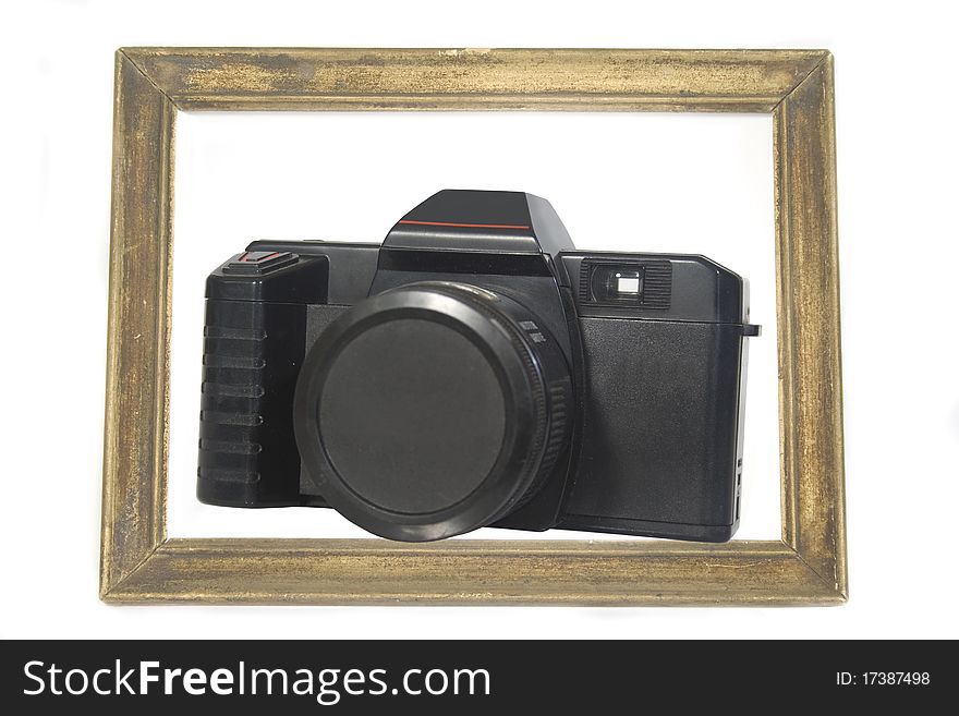 Camera in a wooden photo frame. Camera in a wooden photo frame