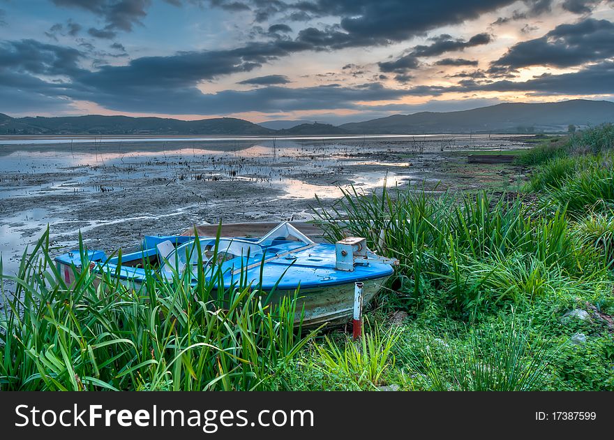 Old Boat At Lakeside At Sunrise