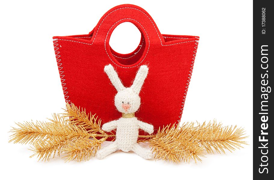 Red bag, golden branches and knitted hare. Red bag, golden branches and knitted hare