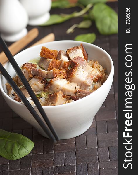 Crispy roast pork with rice in a bowl