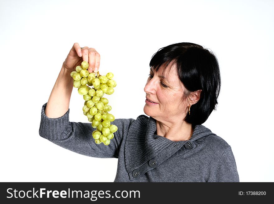 Aged woman with bunch of fresh grapes isolated on white background. Aged woman with bunch of fresh grapes isolated on white background