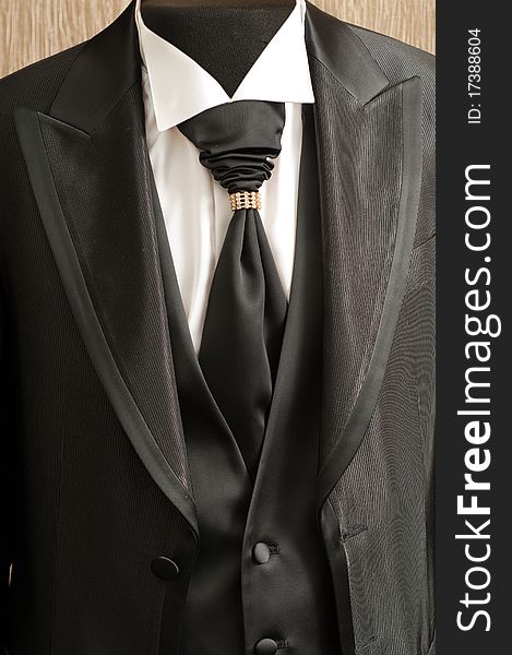 Black fashionable man's suit with a white shirt and a stylish tie. Black fashionable man's suit with a white shirt and a stylish tie.