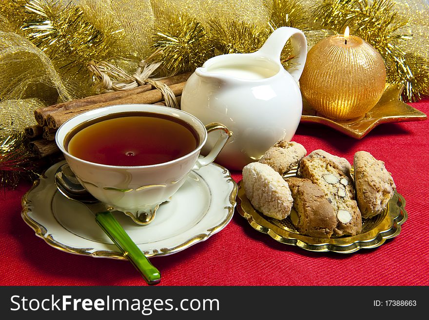 Tea and cookies with Christmas decorations on red background. Tea and cookies with Christmas decorations on red background