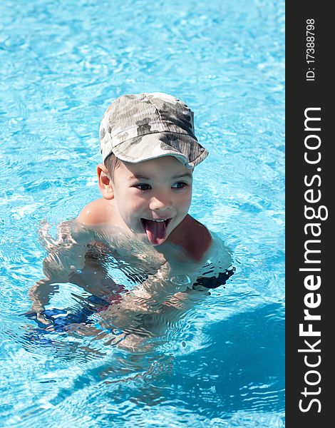 Little joy boy swims in the sea, swim in the pool. Hot sunny summer day, the beach