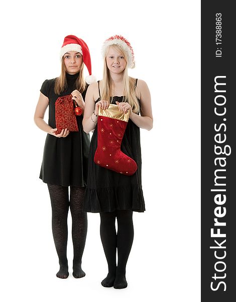 Two girls in the Santa hat and gifts on a white background