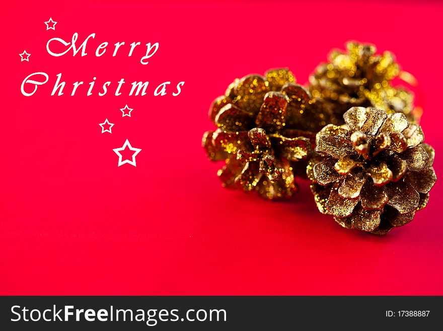 Golden cones on red background;christmas decoration. Golden cones on red background;christmas decoration