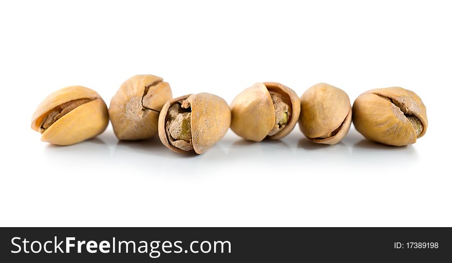 Ripe pistachios isolated on a white background. Ripe pistachios isolated on a white background