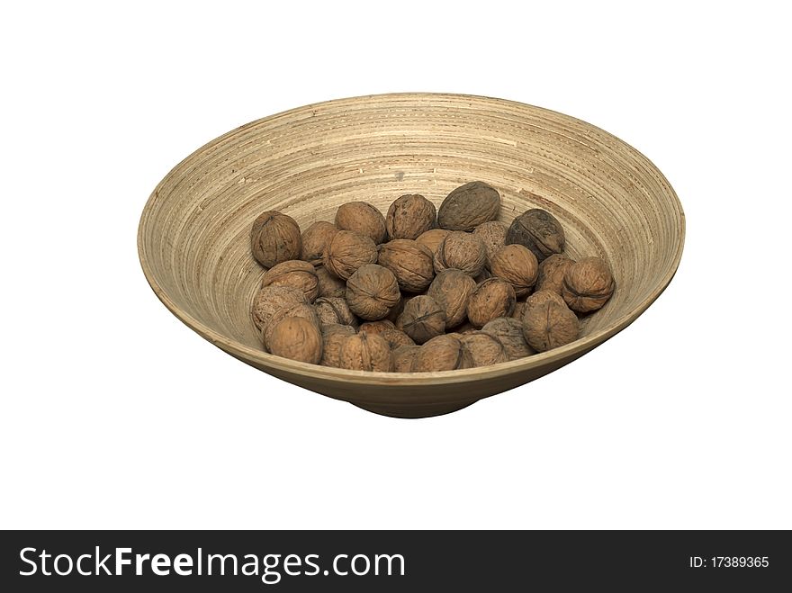 Isolated wooden bowl with walnuts