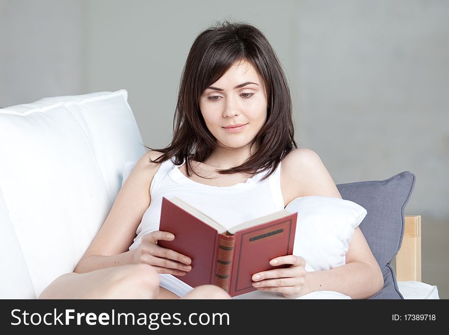Young beautiful girl reads book