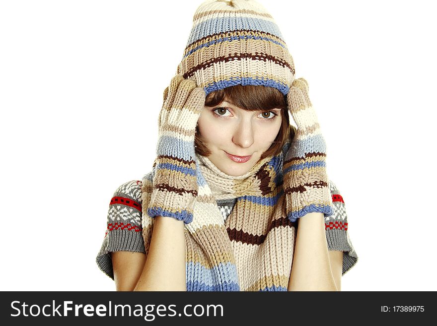 Photo of a young woman in soft sweater, cap and mittens, holding her head between her hands. Isolated on a white background. Photo of a young woman in soft sweater, cap and mittens, holding her head between her hands. Isolated on a white background