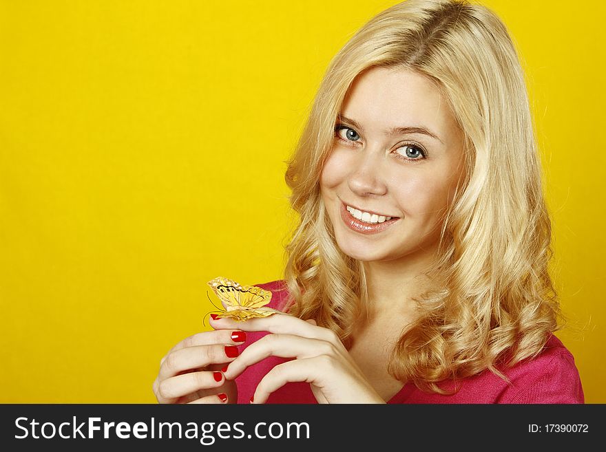 Portrait of a beautiful young woman with a butterfly on a yellow background. Isolated on a white background. Portrait of a beautiful young woman with a butterfly on a yellow background. Isolated on a white background