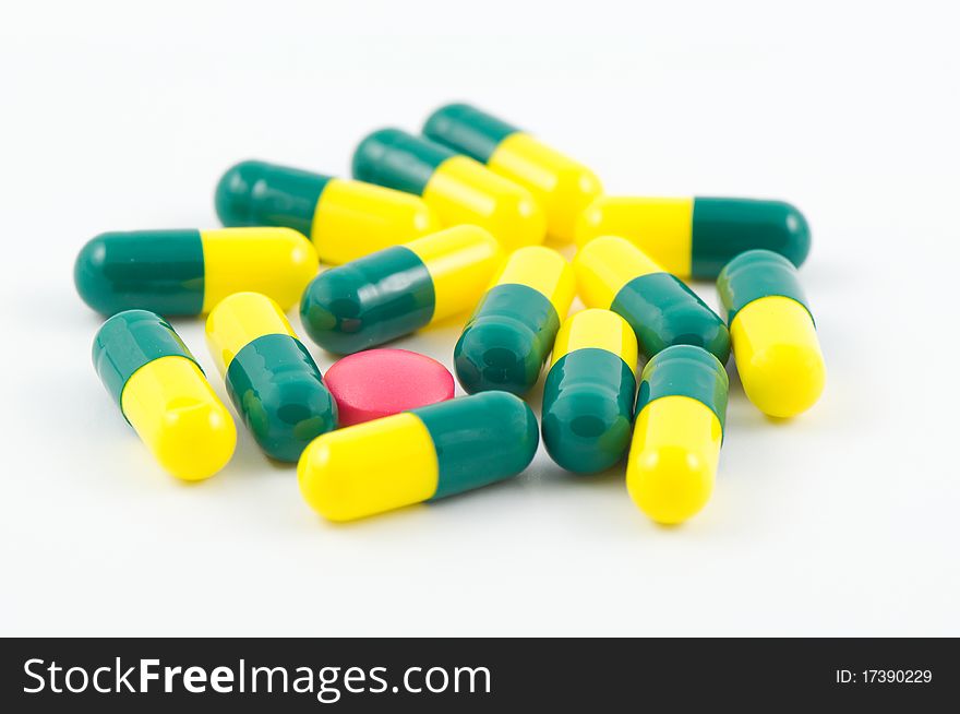 Pink Pills among yellow and green pills