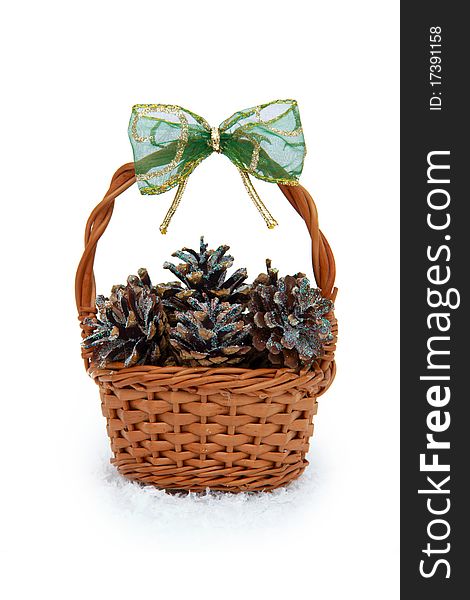 Basket with pine cones on a white background