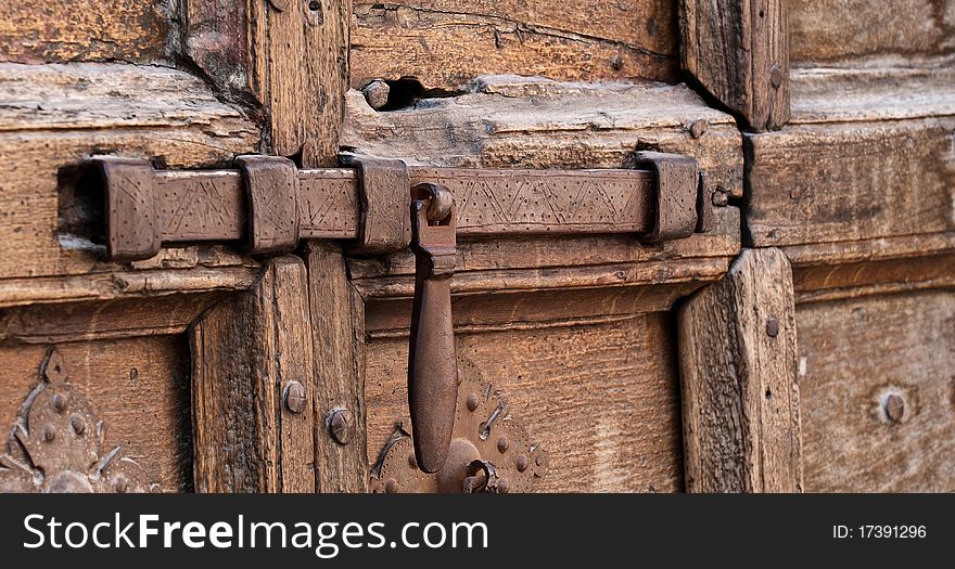Detail of medieval bolt and wooden door in Italy. Detail of medieval bolt and wooden door in Italy
