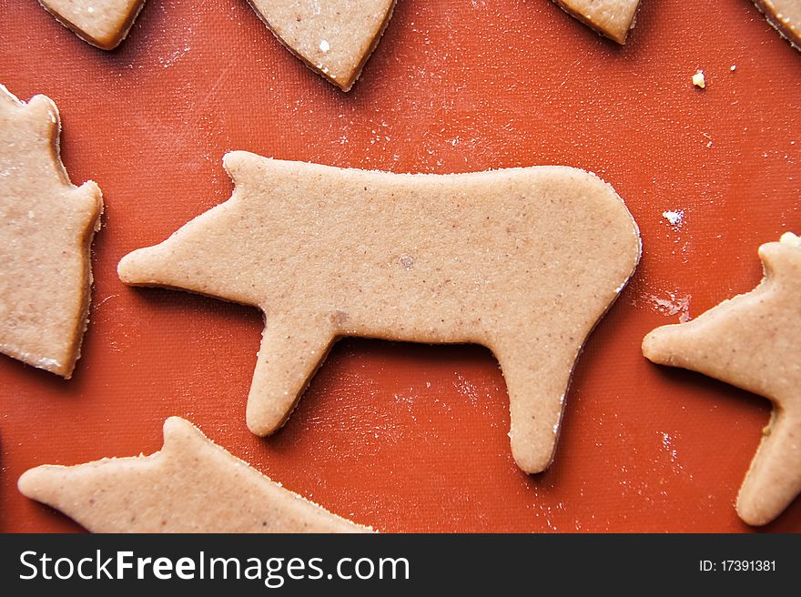 Christmas baking of gingerbread cookies on teflon baking paper. Christmas baking of gingerbread cookies on teflon baking paper