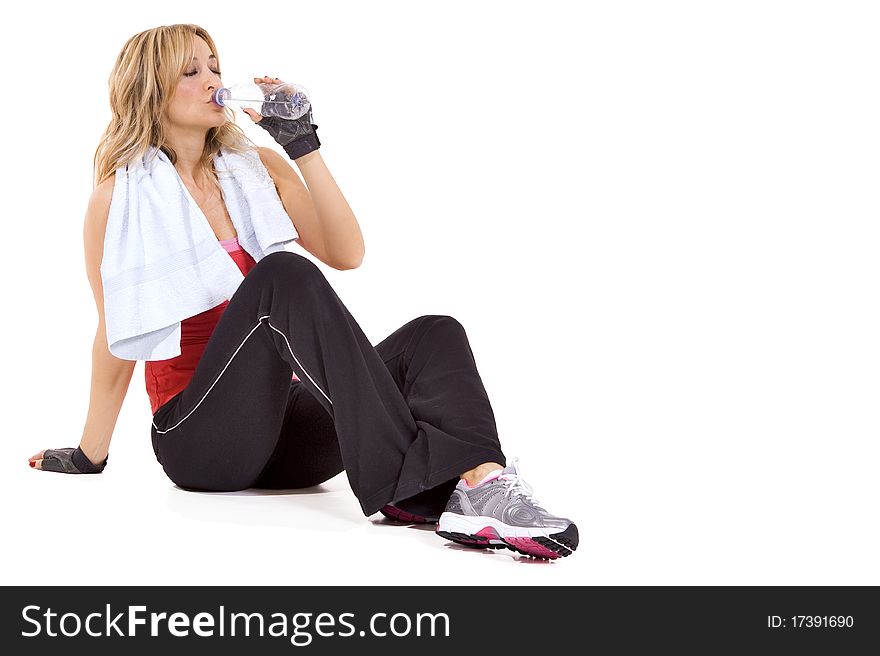 Young woman drinking water after workout