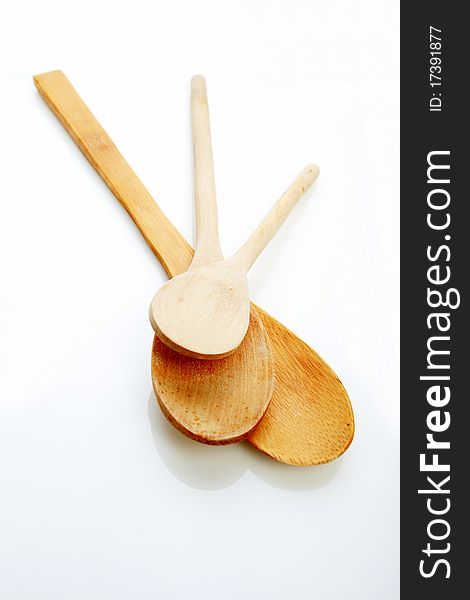 Three kitchen spoons made of wood on the white background. Three kitchen spoons made of wood on the white background