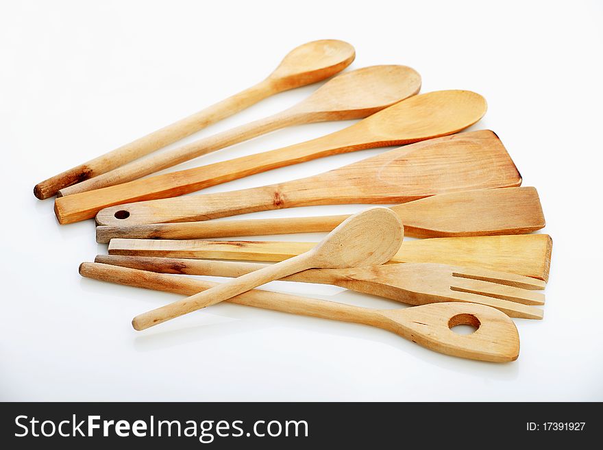 All kind of kitchen spoons made of wood on the white background. All kind of kitchen spoons made of wood on the white background