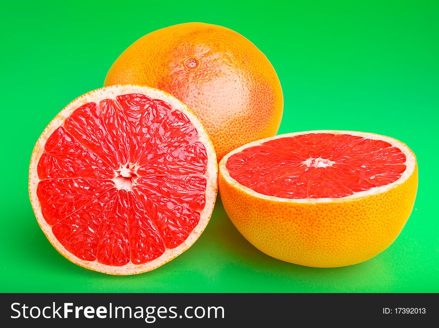 Juicy grapefruit on green background