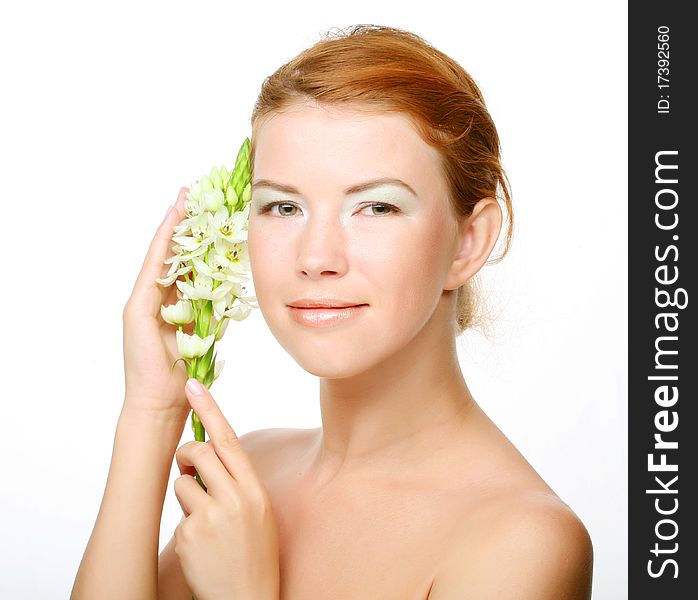 Young cute woman with fresh white flower