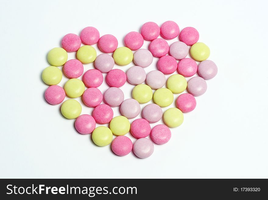 A heart shape made with candies,. A heart shape made with candies,