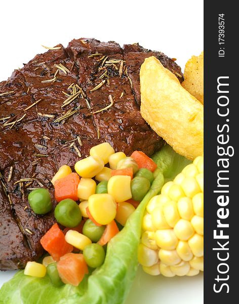 A grilled ribeye steak with baked potato and vegetables.