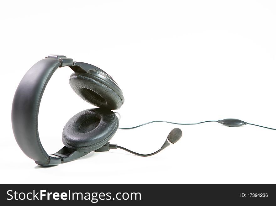 Black ear-phones for music or communication conversations on a white background