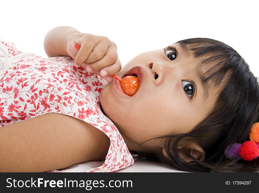 Cute little girl with a lollipop