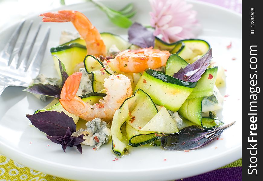 Tasty prawns appetizer with zucchini, cheese and basil