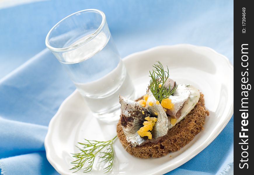 Anchovy canapes garnished with dill and yolk and vodka. Anchovy canapes garnished with dill and yolk and vodka