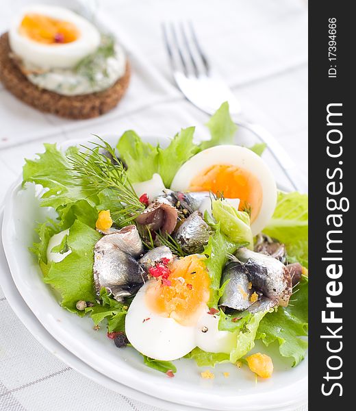 Salad with lettuce, eggs and anchovy on kitchen towel