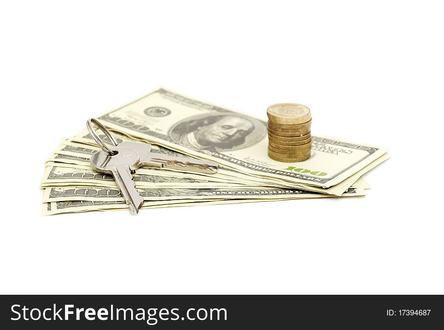 Keys and stack of dollars isolated on a white background