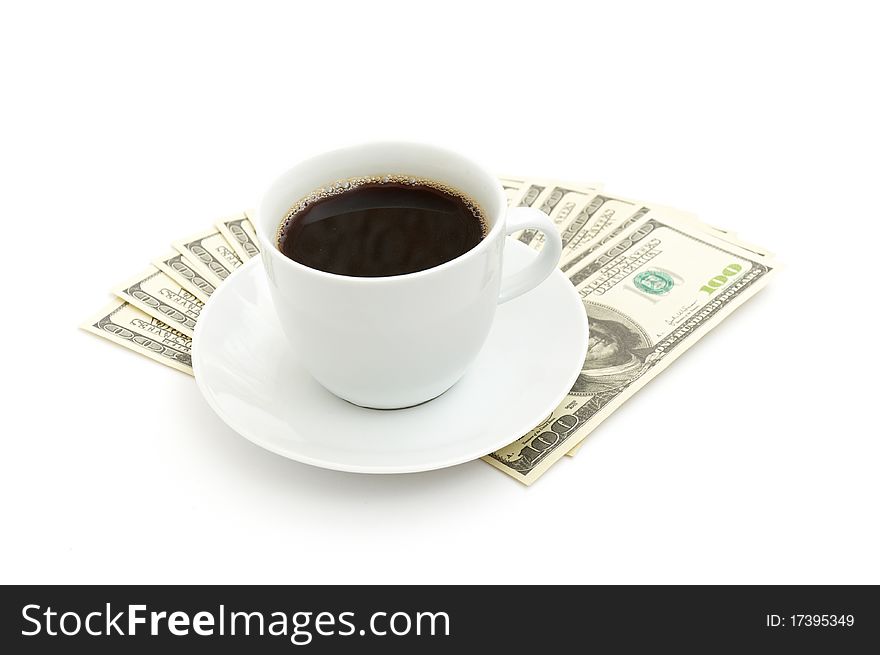 Coffee cup and dollar close up isolated on white